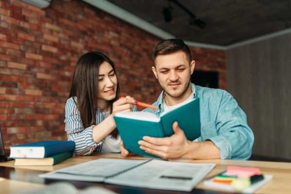 university-students-reading-textbook-together.jpg